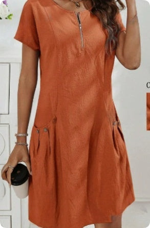 Orange dress worn by a person on a white background