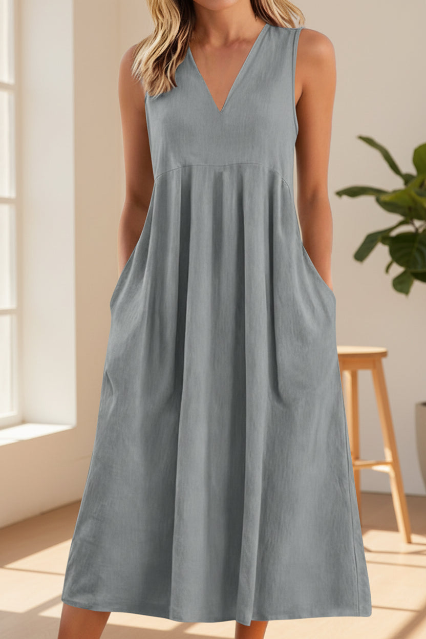 Gray sleeveless dress worn by a person on a white background