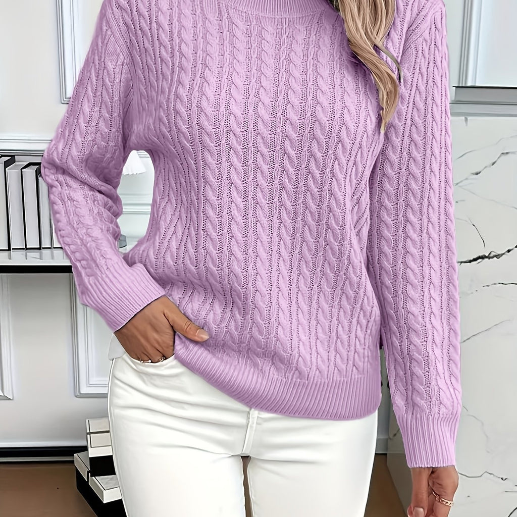 Person wearing a purple cable knit sweater and white pants indoors.