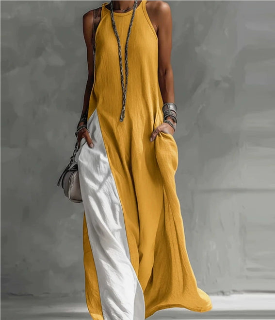 Mustard yellow sleeveless dress with white pants on a neutral background