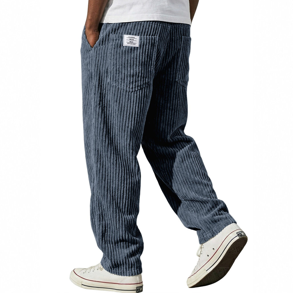 Blue corduroy pants worn by a person on a white background