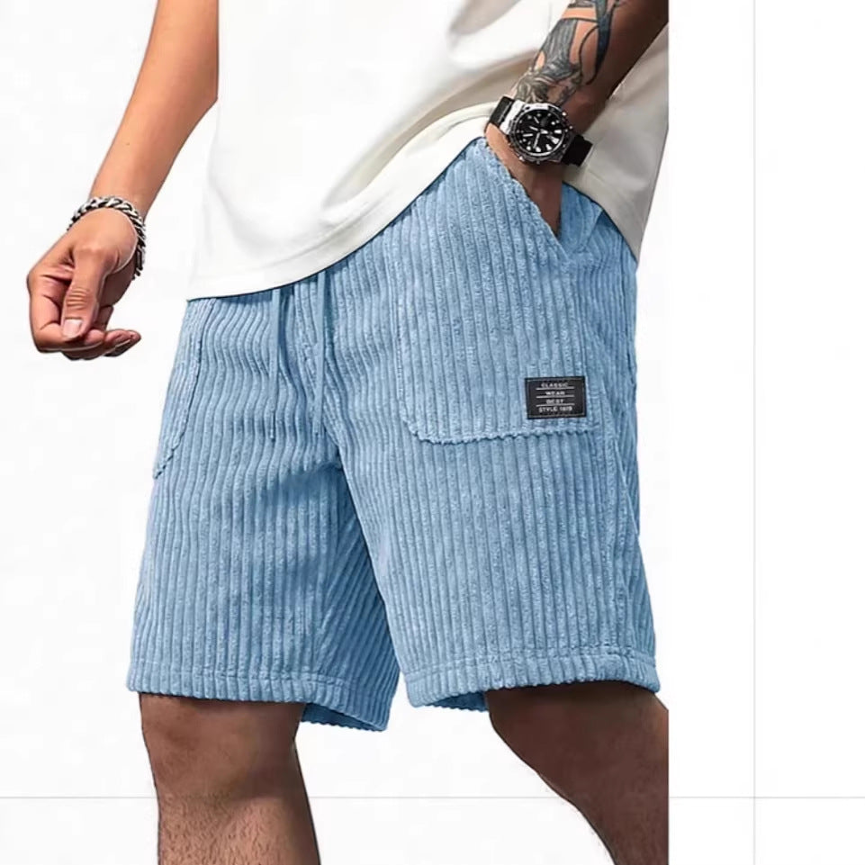 Light blue corduroy shorts worn by a person on a white background