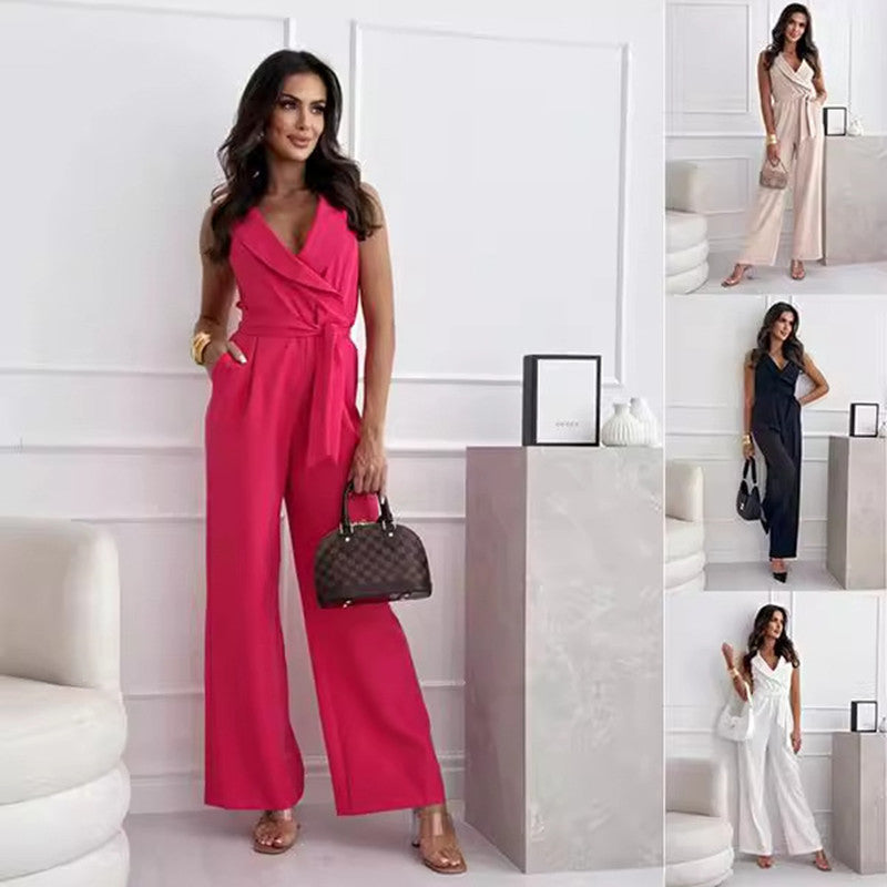Woman in a pink jumpsuit holding a handbag in a minimalistic setting