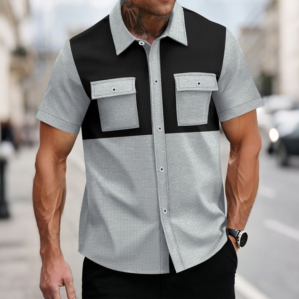 Man wearing a black and gray checkered shirt with a blurred street background
