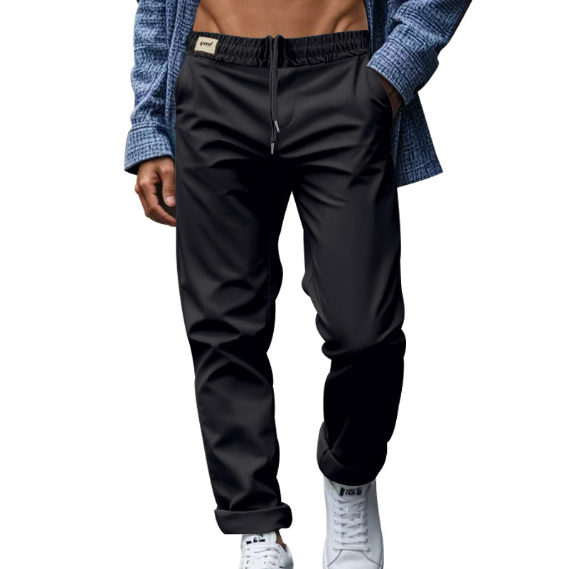 Person wearing black pants with a blue jacket on a white background
