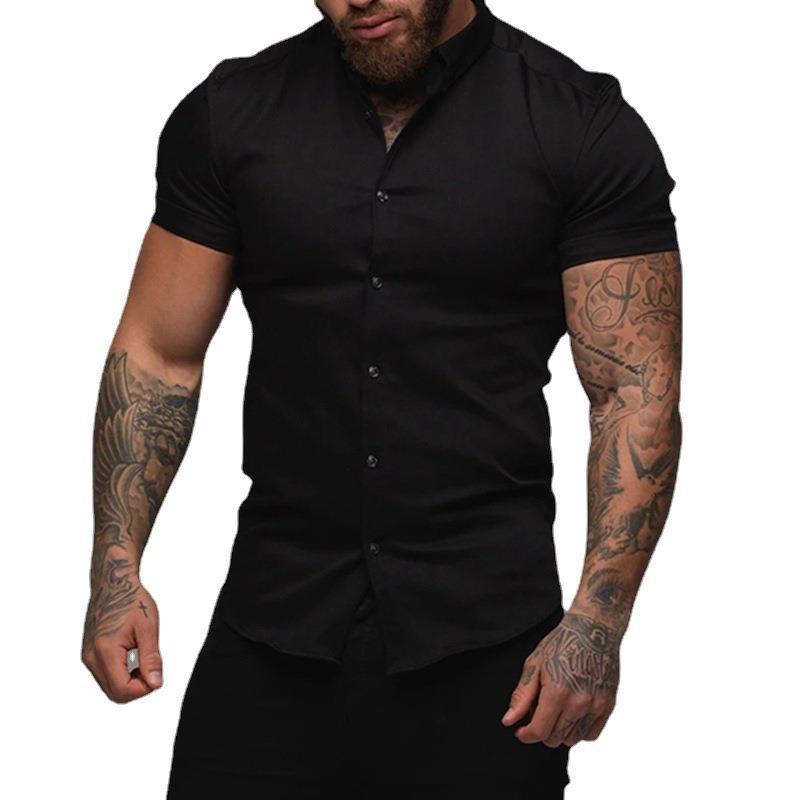 Man wearing a black short-sleeve shirt with tattoos on arms against a white background