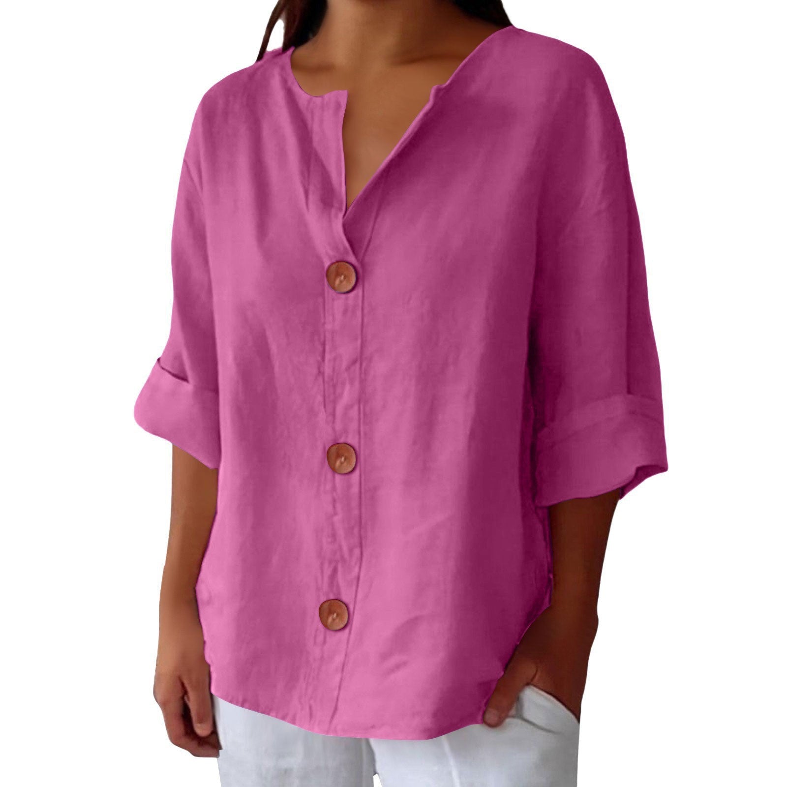 Pink button-up shirt worn by a person on a white background