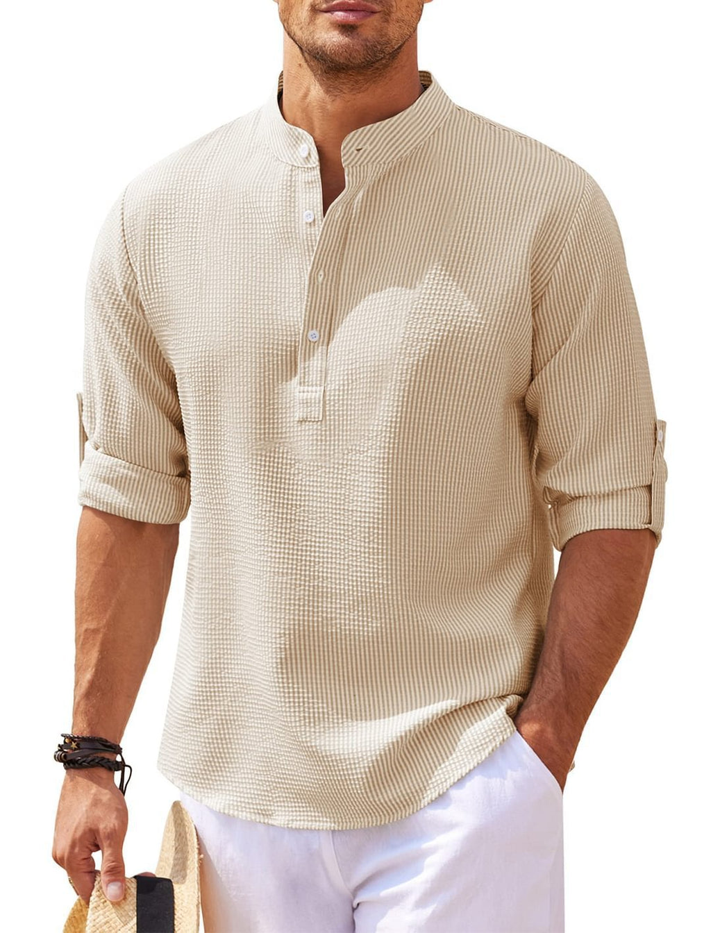 Man wearing a beige textured shirt with rolled-up sleeves on a white background