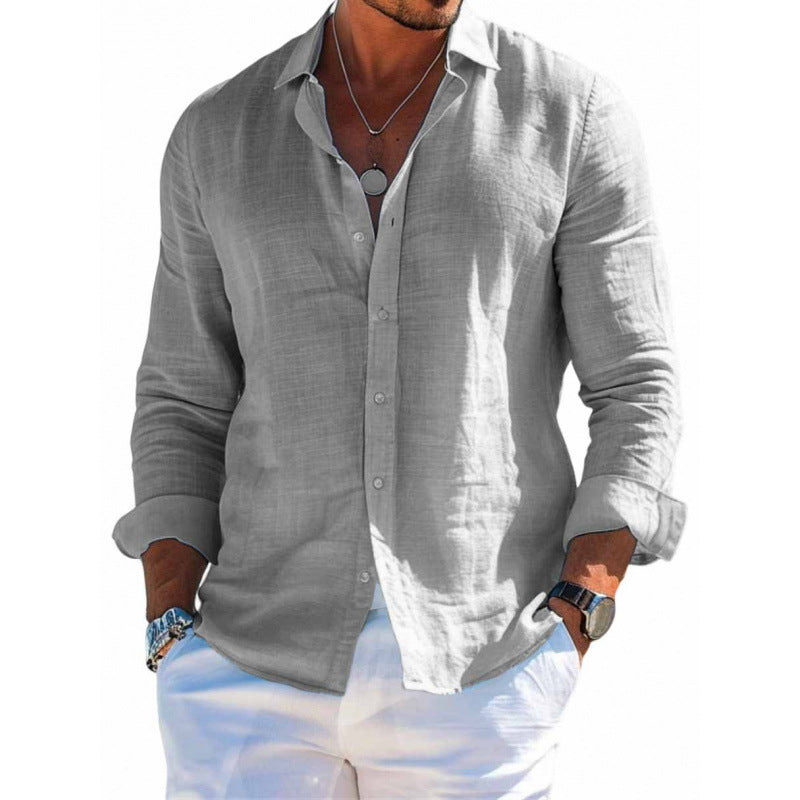Man wearing a light gray button-up shirt and white pants on a white background