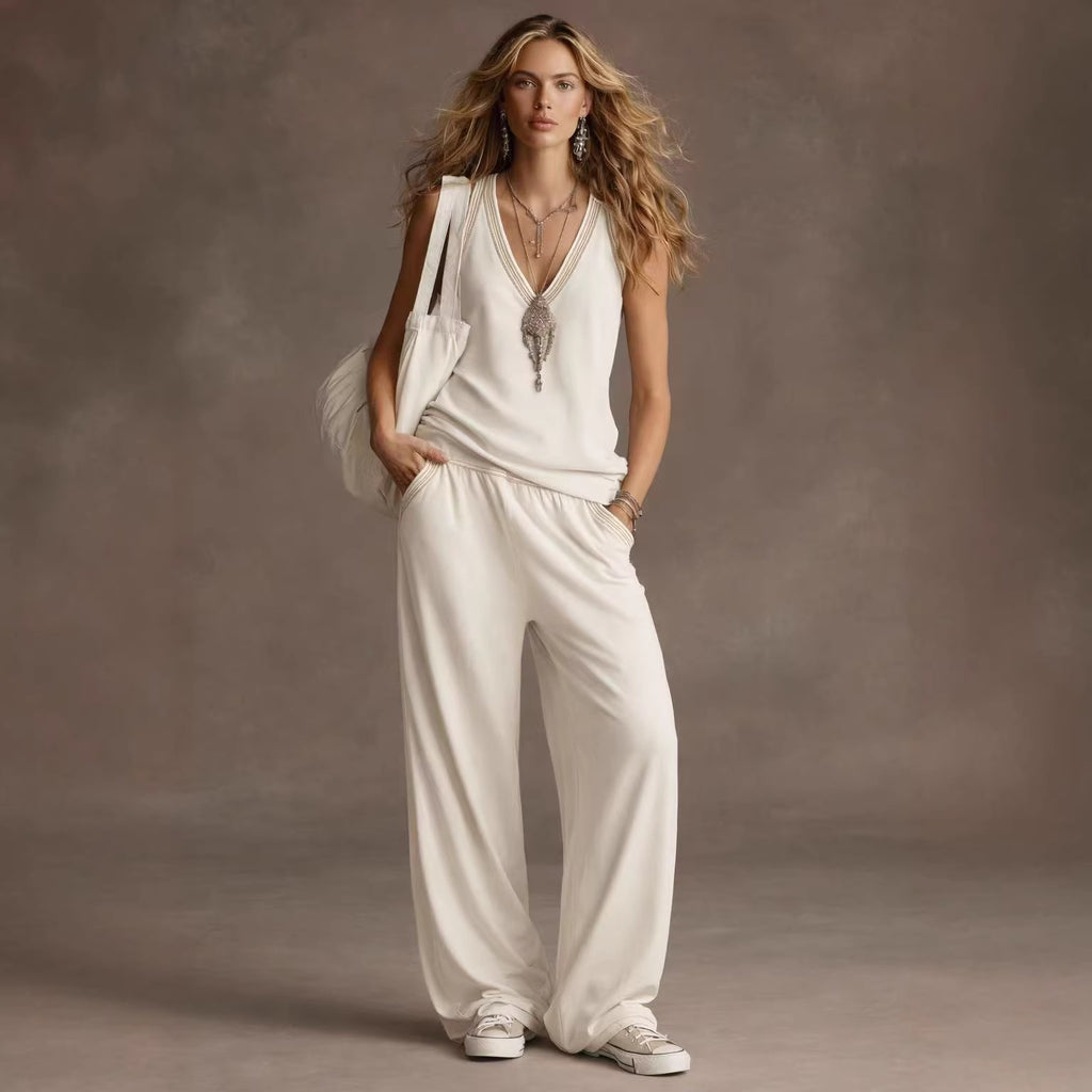 Woman wearing a white outfit against a brown background