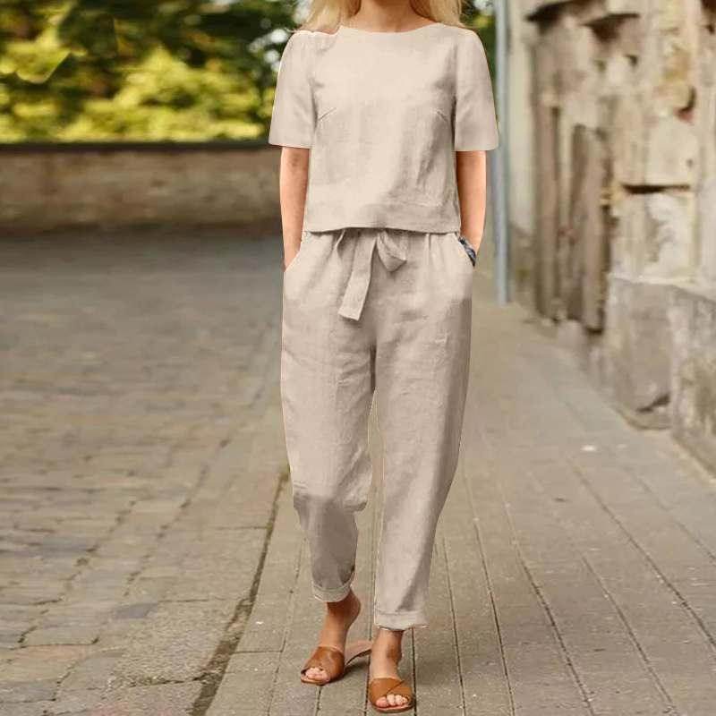 Woman wearing beige linen two-piece outfit from ZA-Zola, walking on a city street