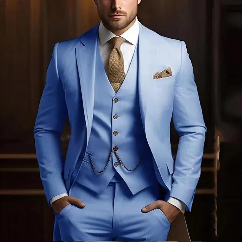 Man wearing a light blue suit with a brown tie and pocket square against a blurred background
