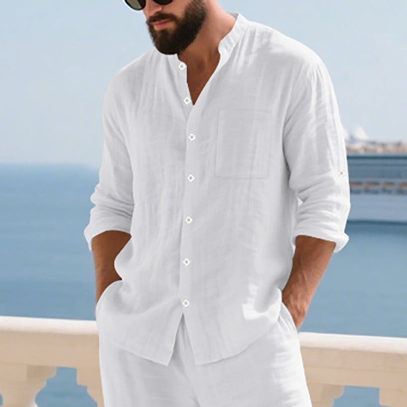 Man wearing a white shirt and pants with a scenic background