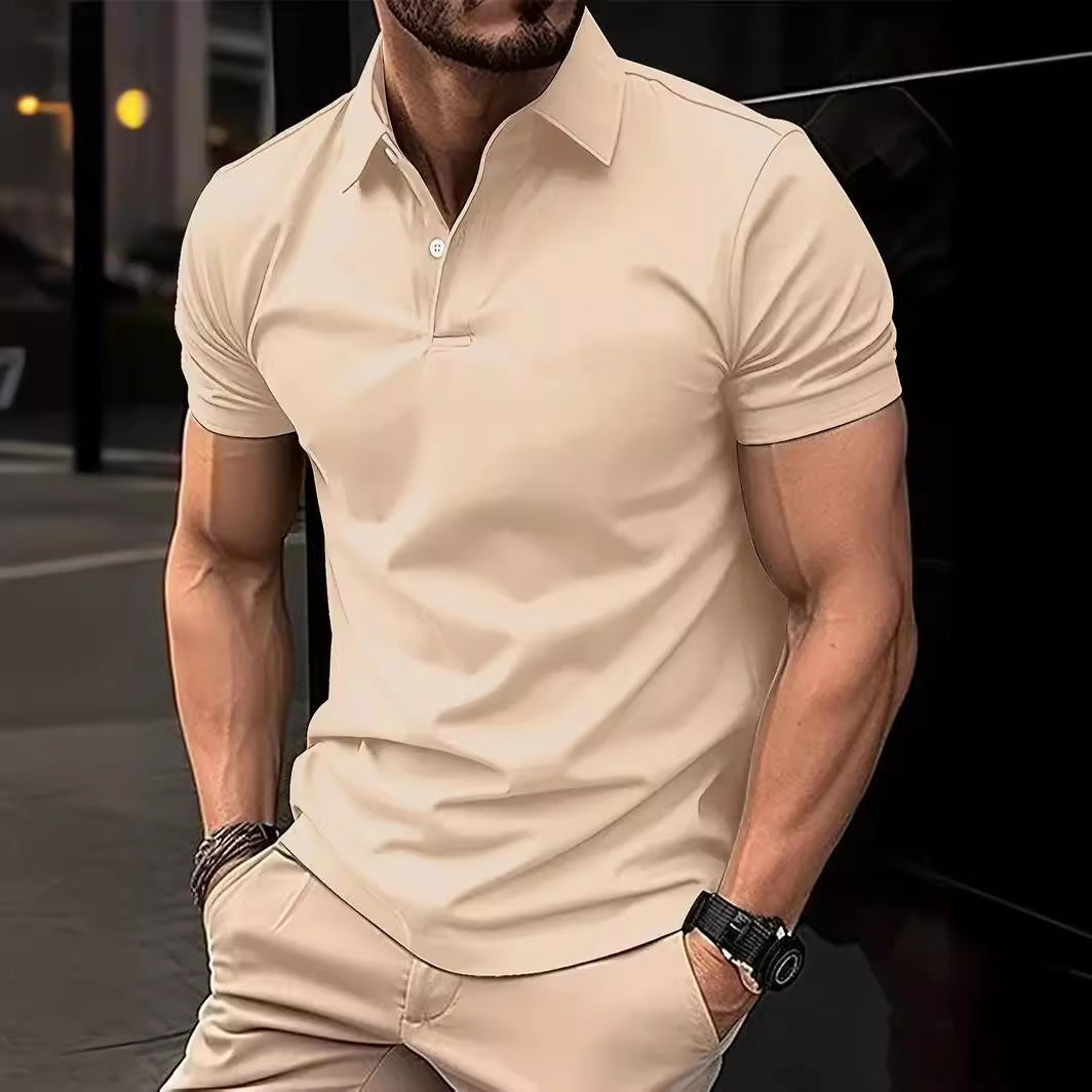 Man wearing a beige short-sleeve shirt and pants in an urban setting