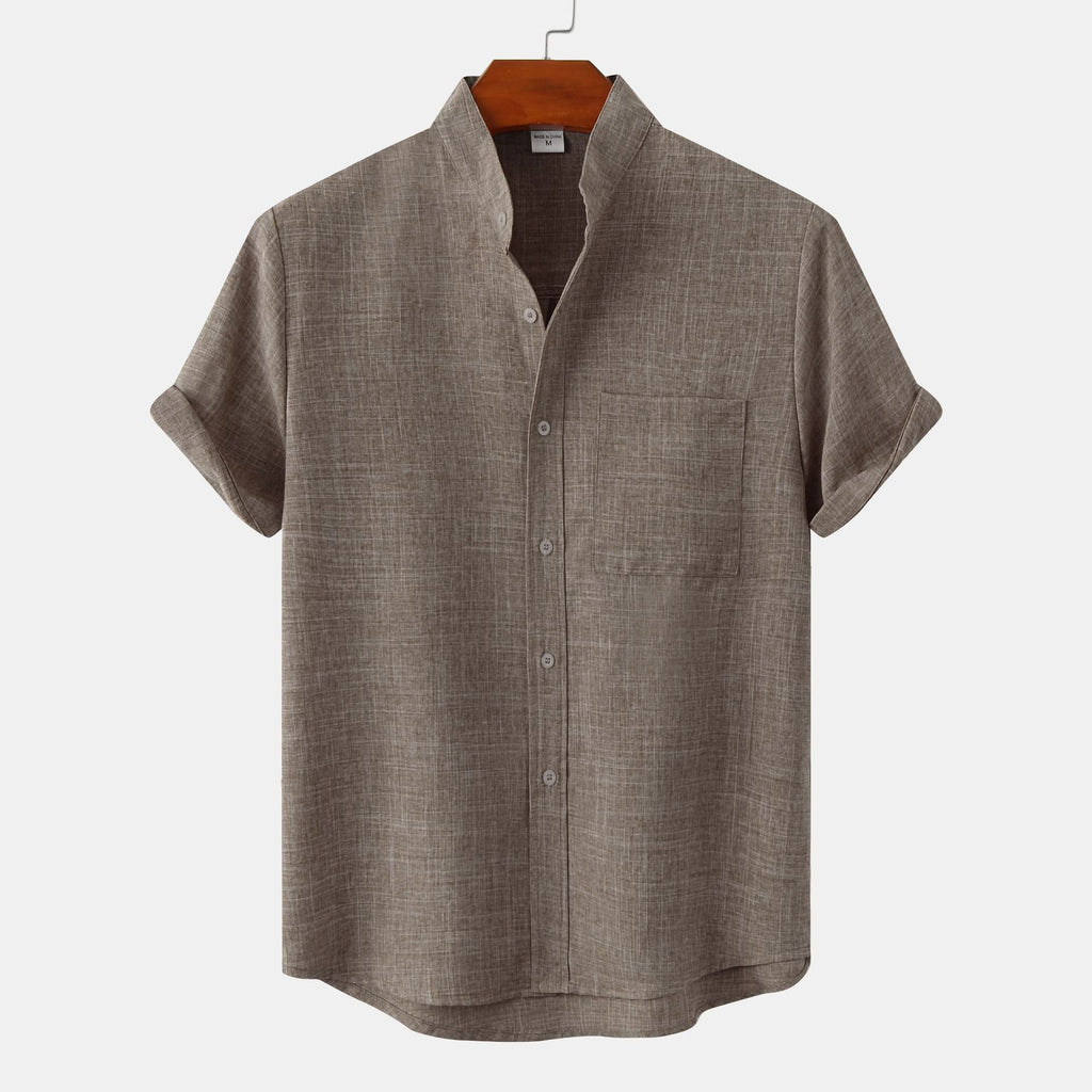 Green short-sleeve shirt on a hanger against a white background