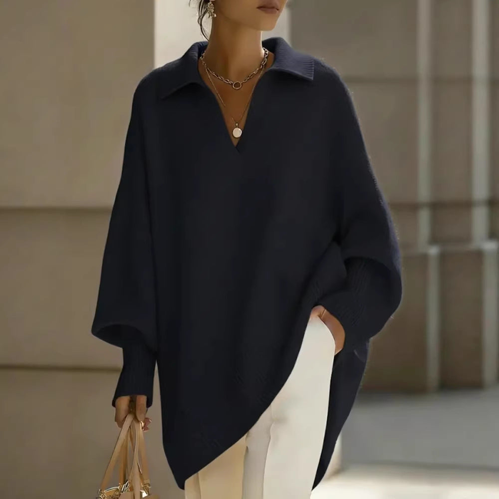 Person wearing a navy blue poncho with a blurred background