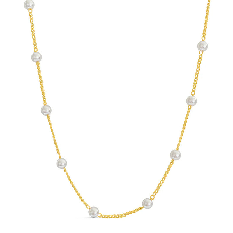 Gold necklace with pearls on a white background