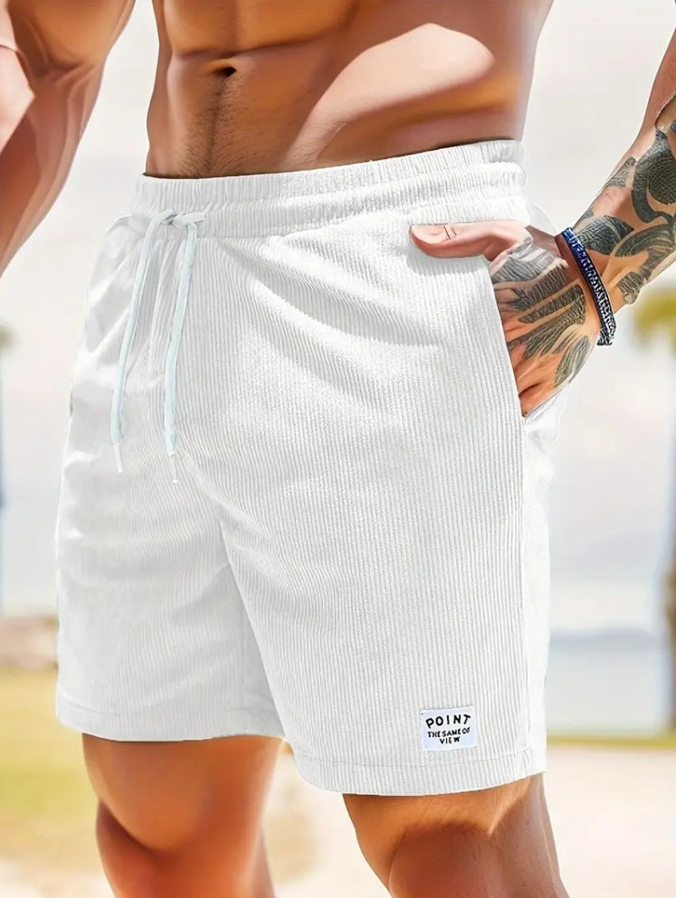 Person wearing white athletic shorts with a blurred background