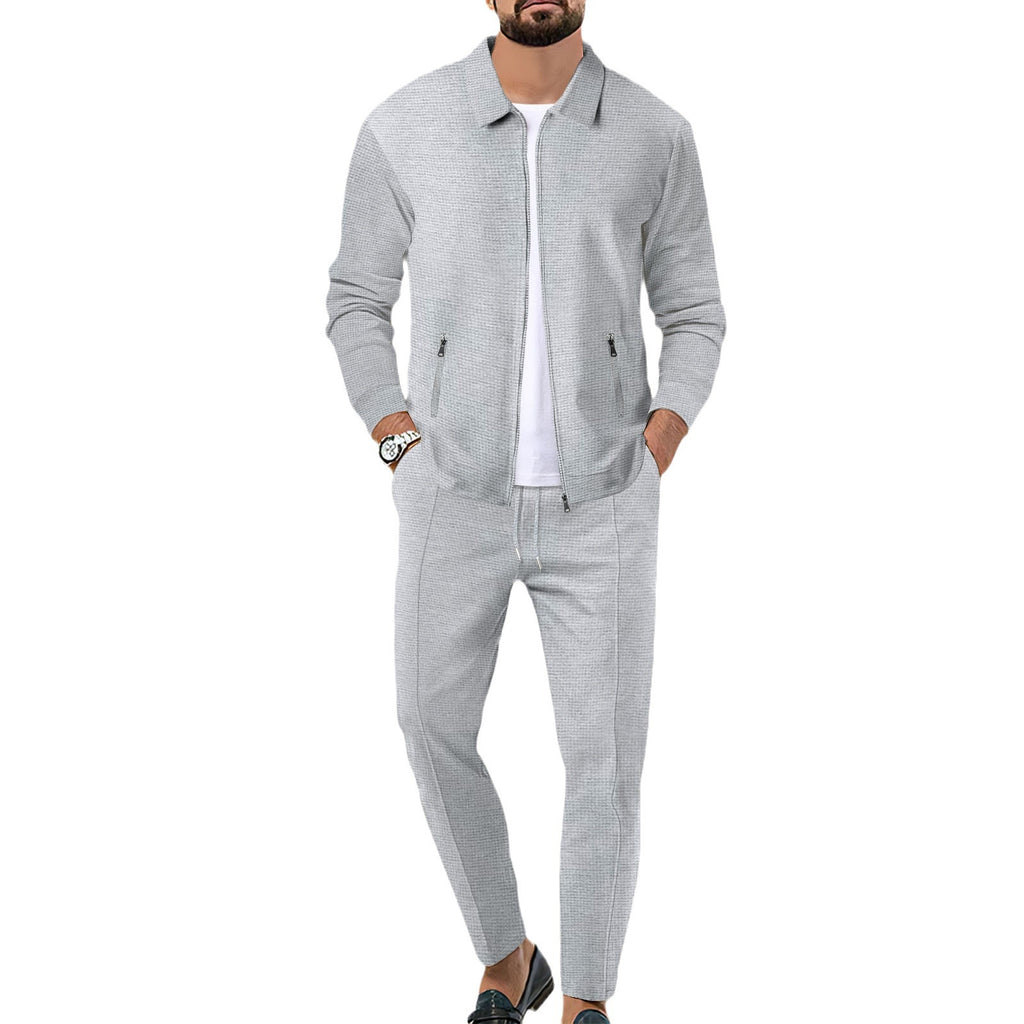 Man wearing a gray tracksuit on a white background