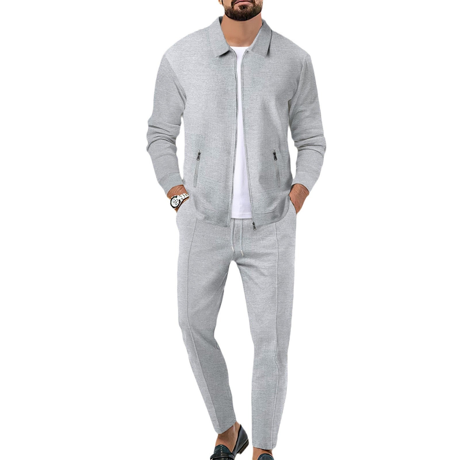 Man wearing a gray tracksuit on a white background