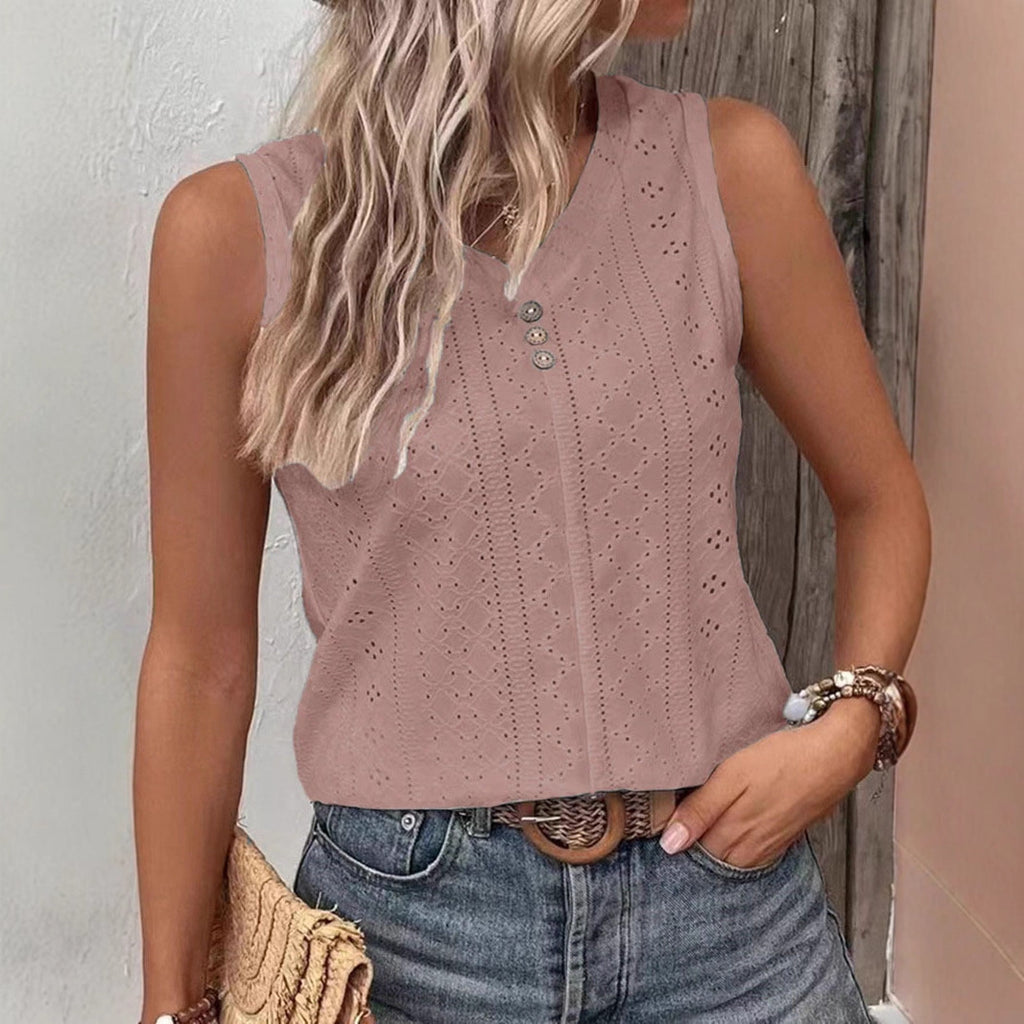 Woman wearing a pink sleeveless top with button details against a neutral background