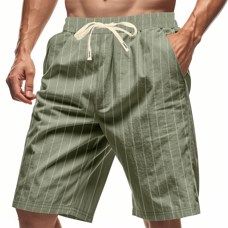 Green pinstripe shorts worn by a person on a white background