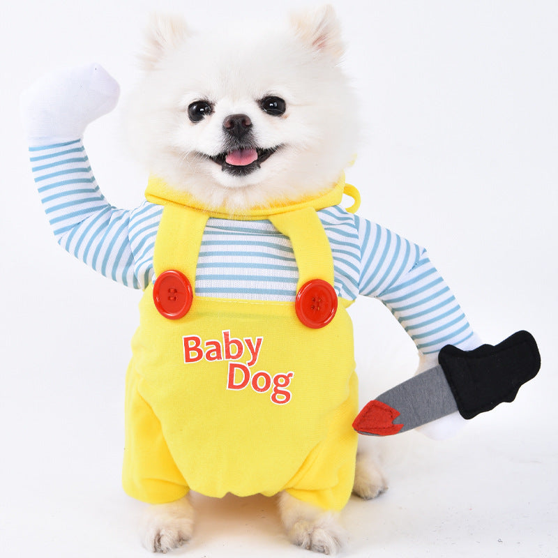 White dog wearing a yellow 'Baby Dog' outfit with red buttons on a white background