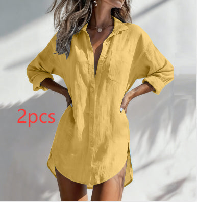 A woman wearing an oversized yellow linen button-up shirt dress with three-quarter sleeves and side slits, posed against a white wall with leaf shadows. Red text overlay reads '2pcs'.