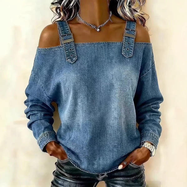 Blue denim off-shoulder sweatshirt worn by a person on a beige background