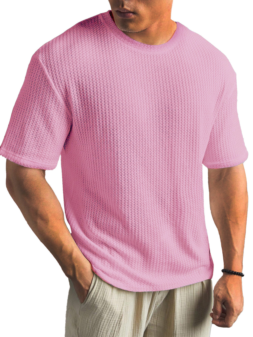 Person wearing a pink textured t-shirt on a white background
