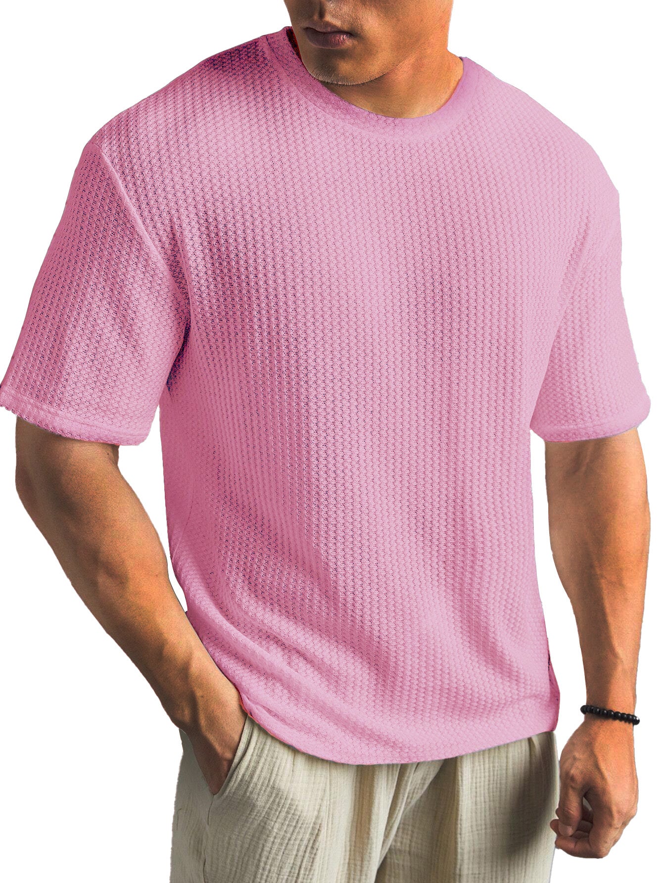 Person wearing a pink textured t-shirt on a white background