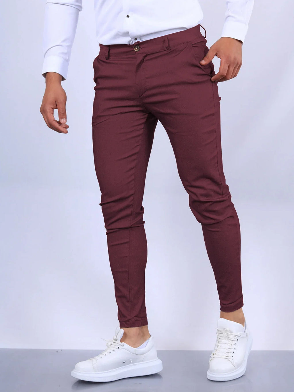 Maroon pants worn by a person on a white background