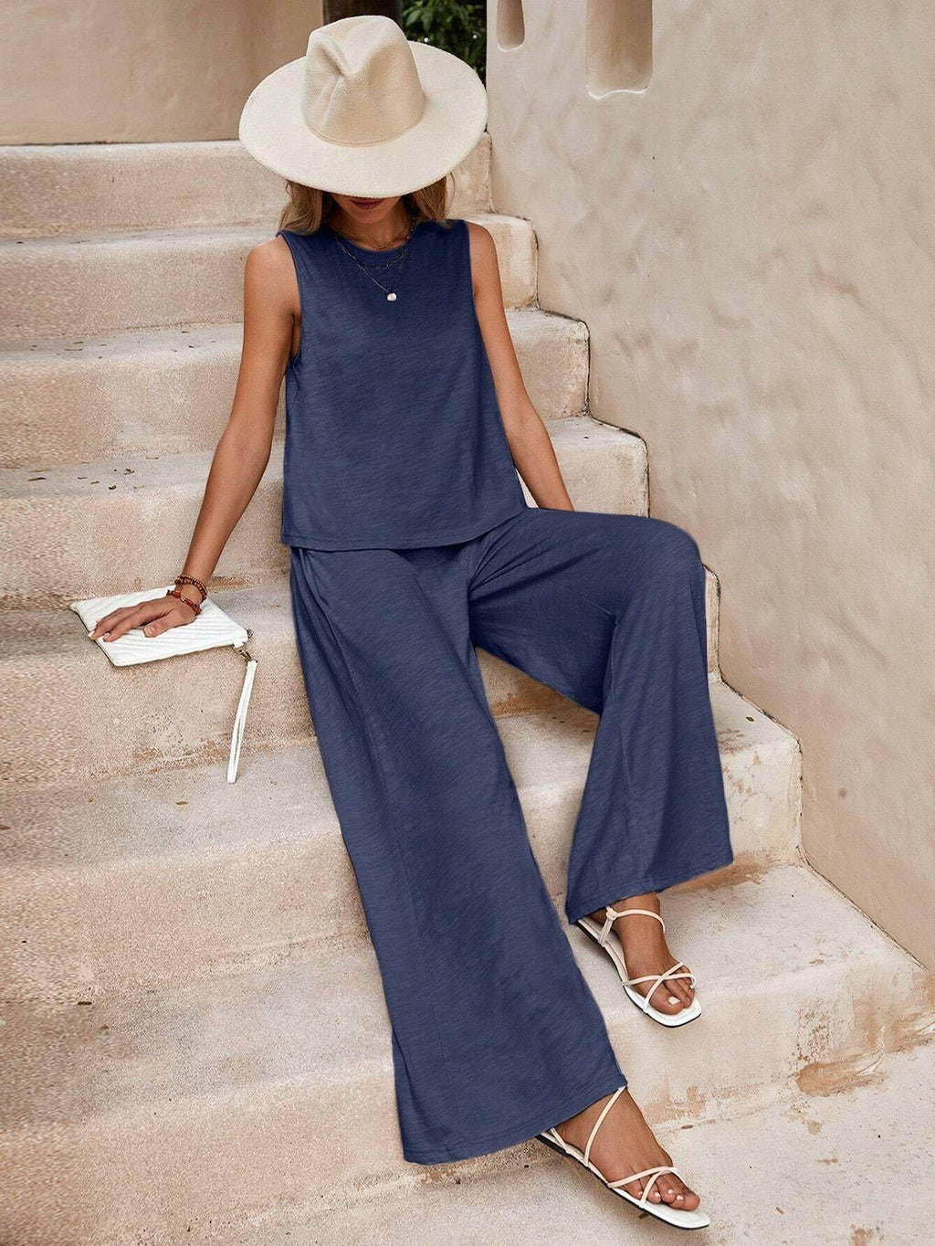 Woman in blue sleeveless set and wide-leg pants, beige hat, white sandals, ZA-Zola fashion