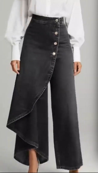 Black wide-leg pants with button details worn by a person on a gray background