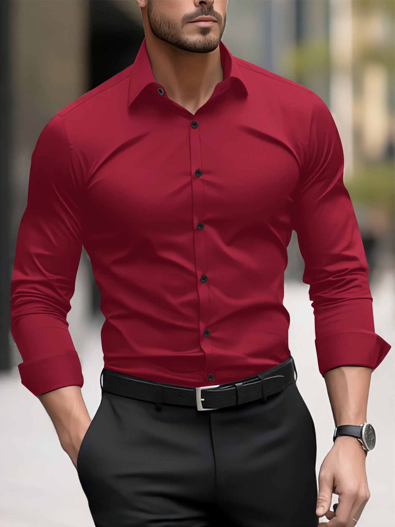Man wearing a red dress shirt and black pants with a blurred background