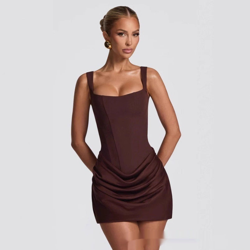 Woman wearing a brown dress against a plain background