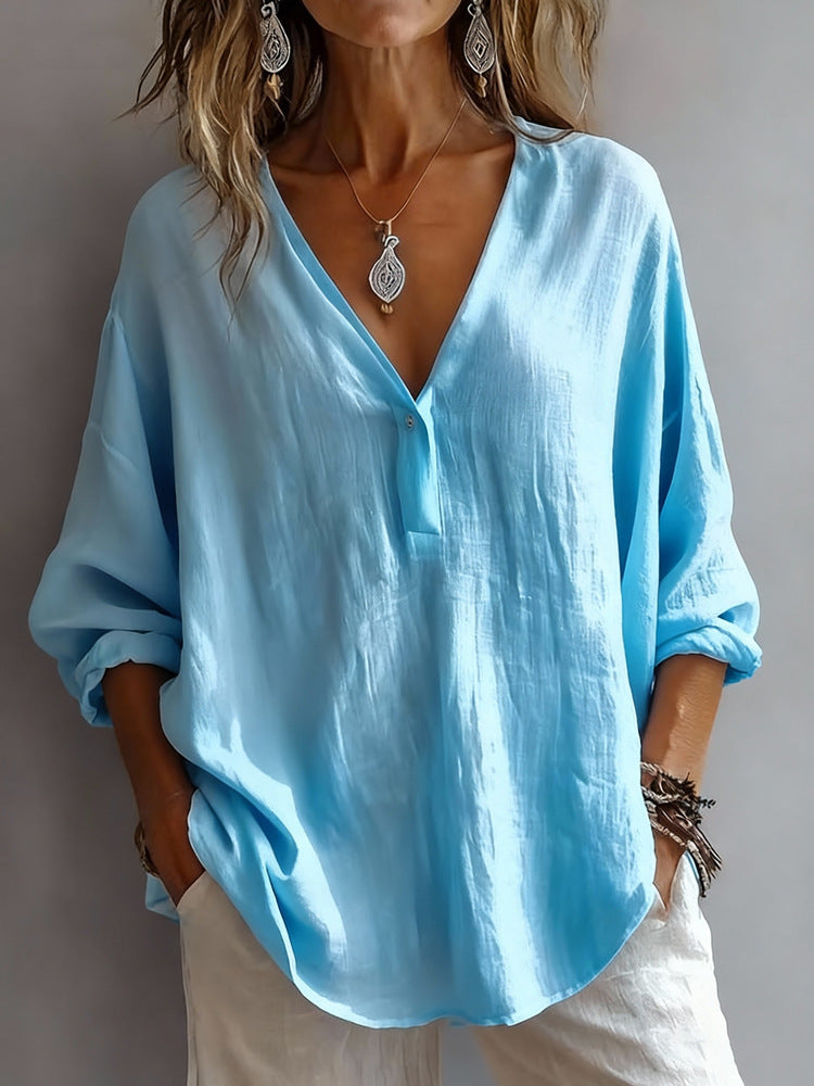 Light blue blouse worn by a person against a neutral background