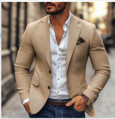 Man wearing a beige blazer over a white shirt with a blurred street background