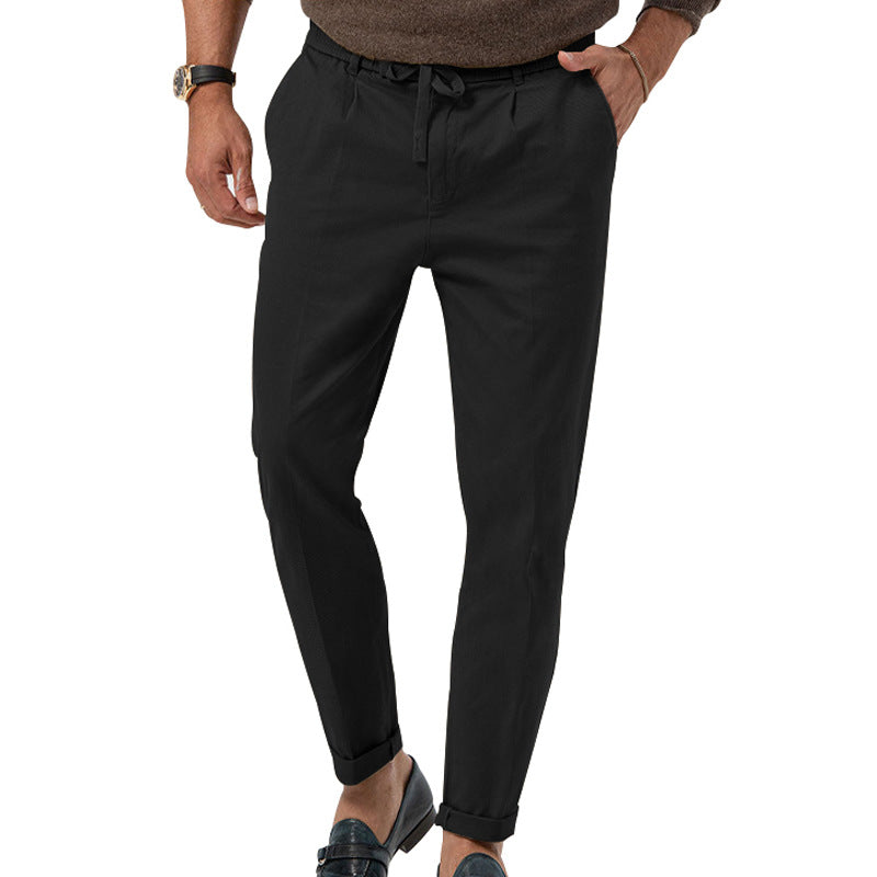 Black pants worn by a person on a white background