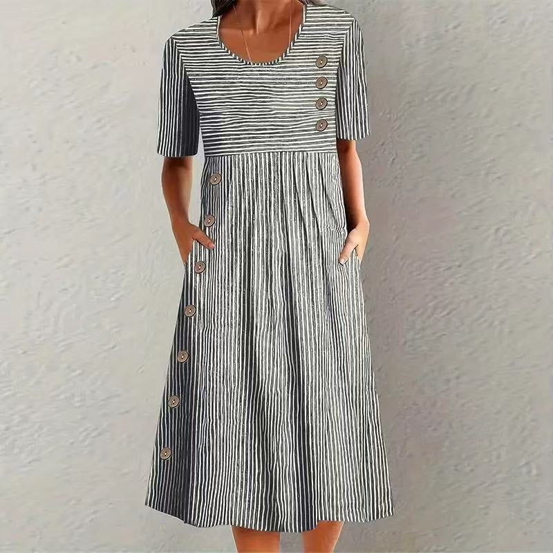 Black and white striped dress with buttons on a textured white background