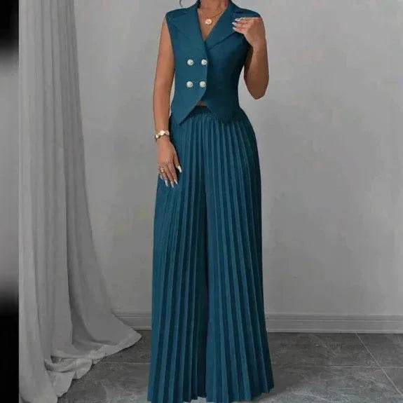 Woman in teal sleeveless blazer top and pleated skirt from ZA-Zola fashion collection