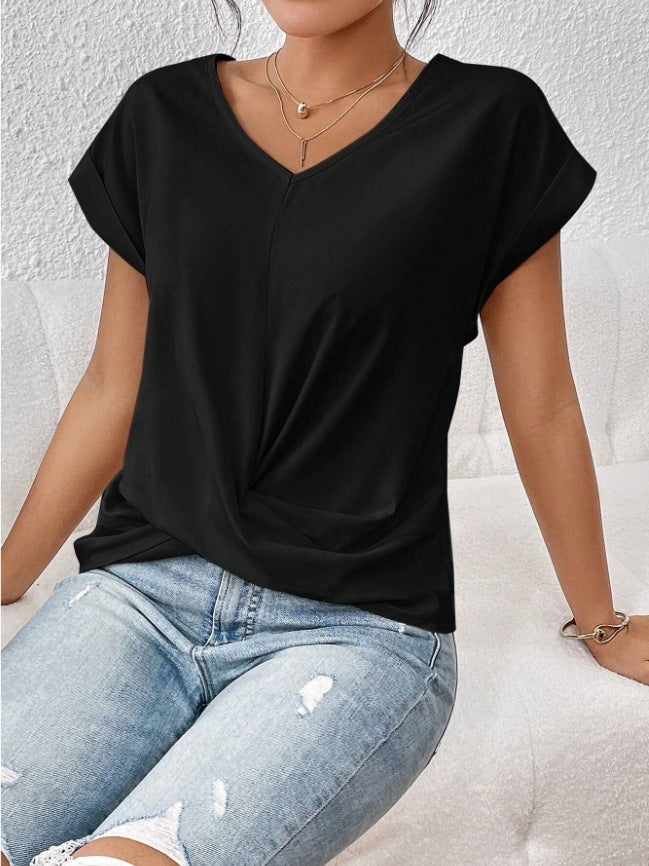 Person wearing a black t-shirt and light blue jeans against a white background