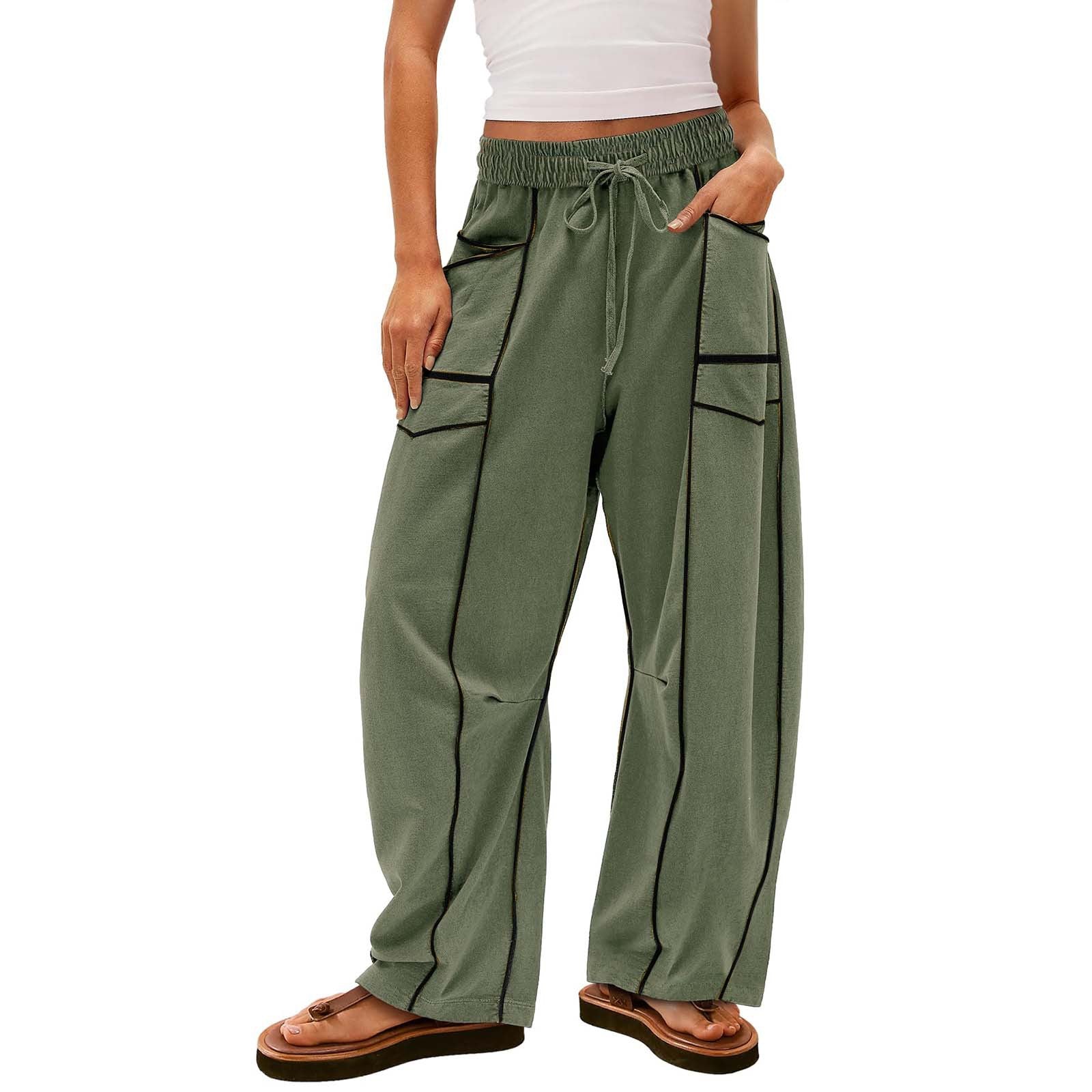 Green hiking pants worn by a person on a white background
