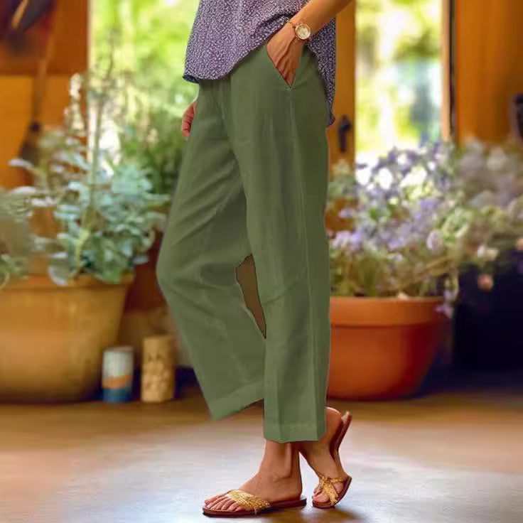 Person wearing green pants with cut-out design in a garden setting
