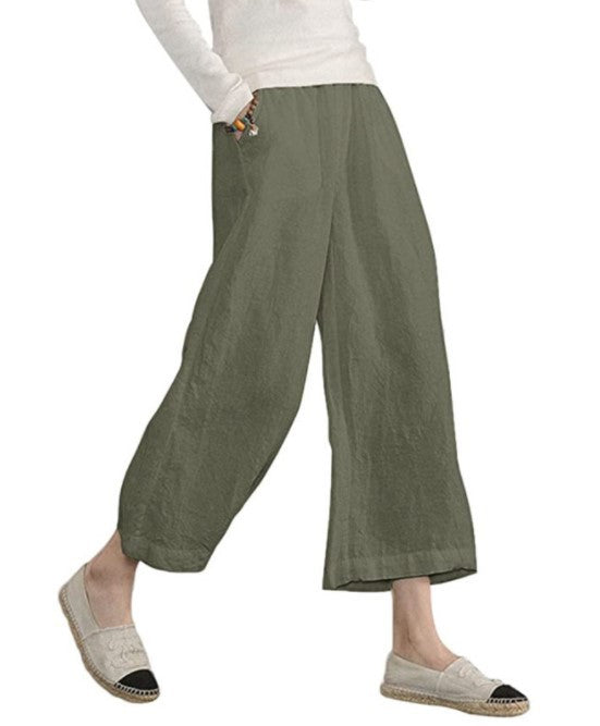 Green wide-leg pants worn by a person on a white background