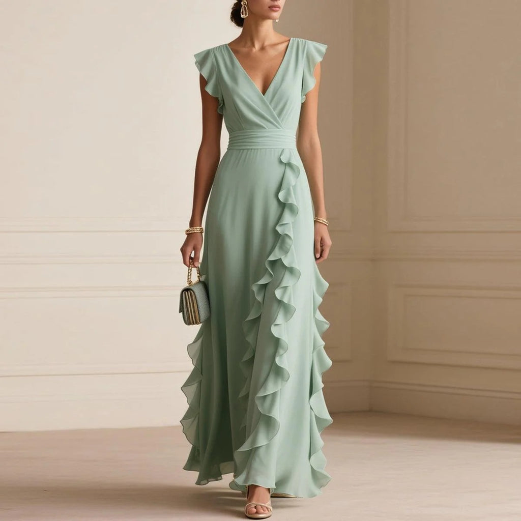 Woman wearing a light green ruffled dress in an elegant room.