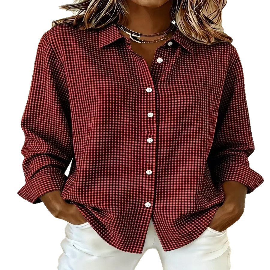 A woman wearing a long-sleeve button-up shirt with a small red and white gingham check pattern, paired with white pants, shown against a plain white background.