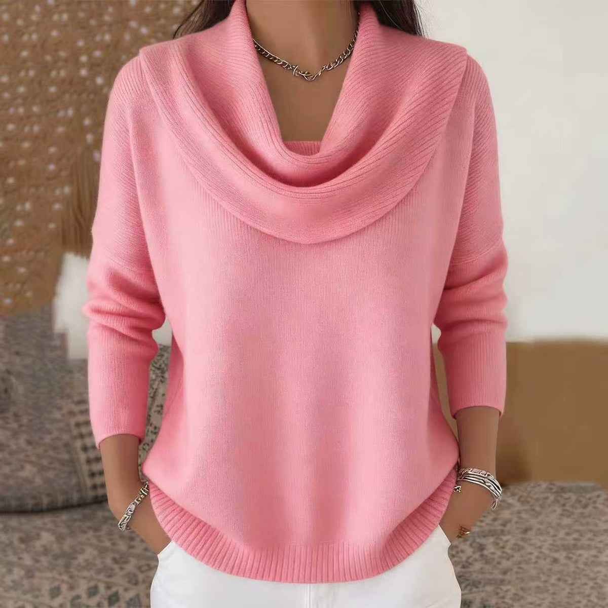 Pink cowl-neck sweater worn by a person with a blurred background