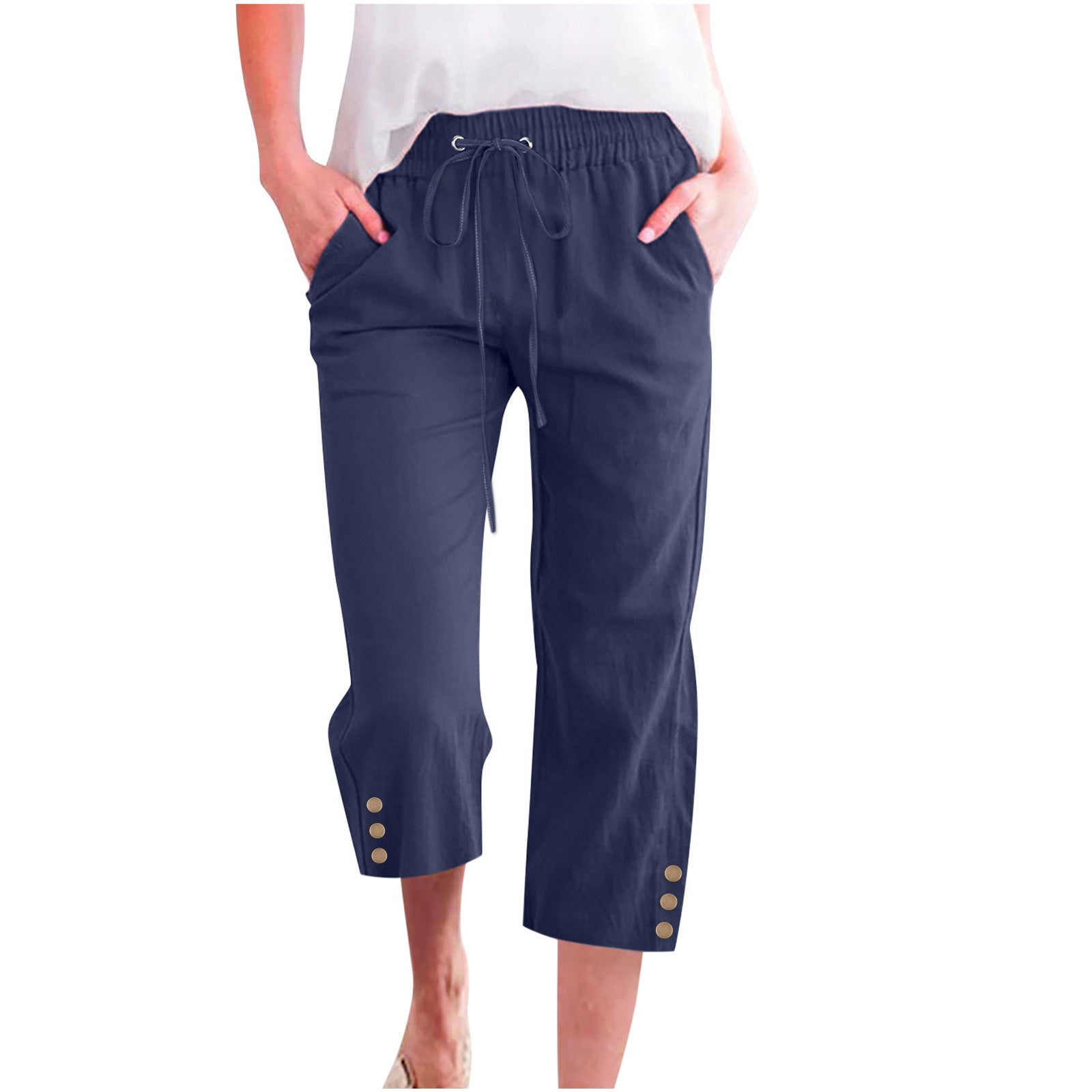 Navy blue capri pants with button details on a white background