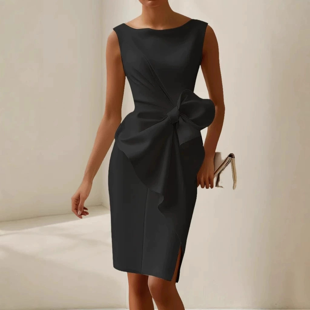Black dress with a large bow detail on a neutral background